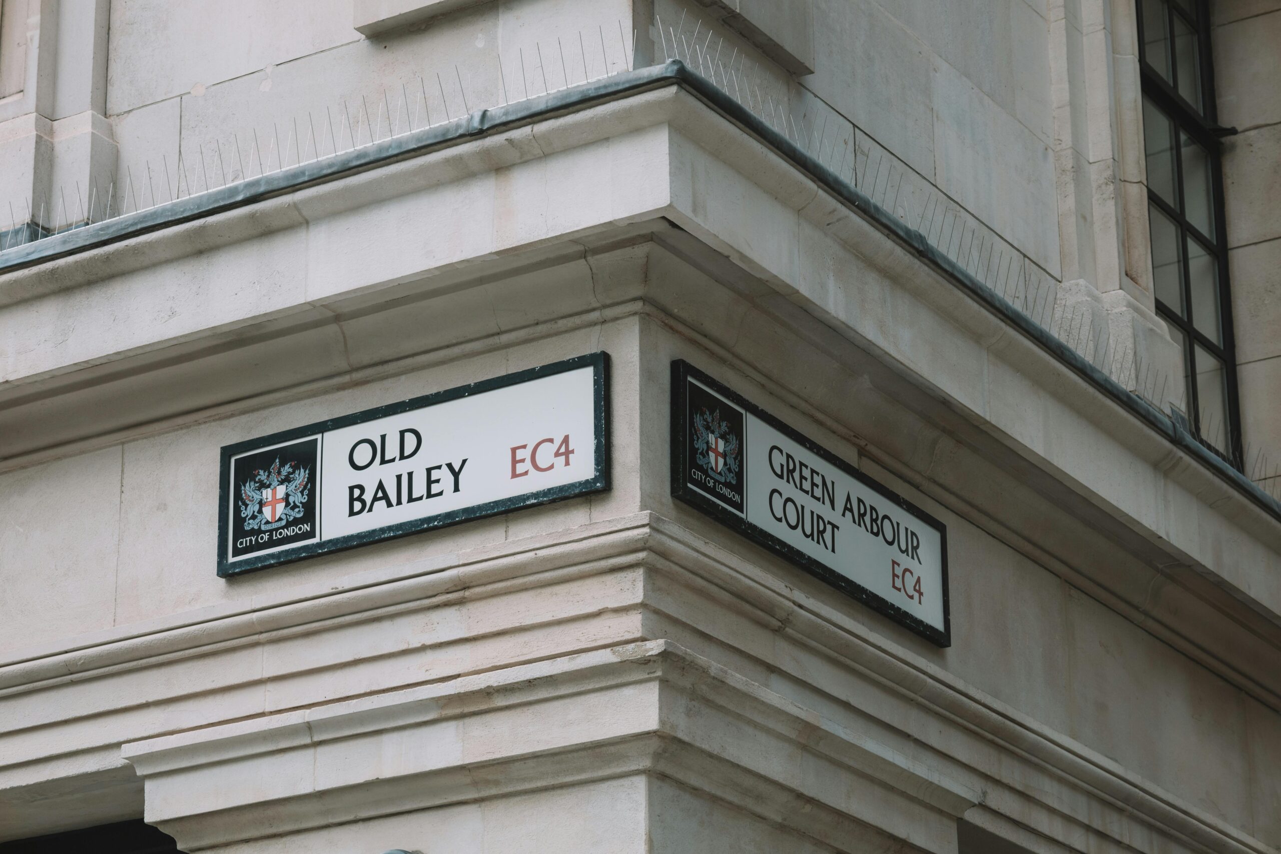 Street signs at Old Bailey and Green Arbour Court in London, England.